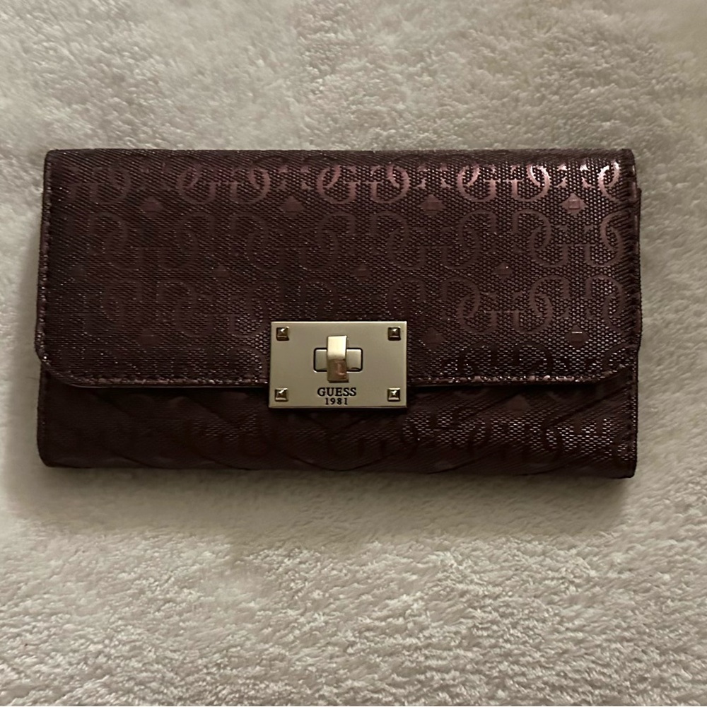 Guess, purple-toned maroon wallet with textured logo design and a silver clasp